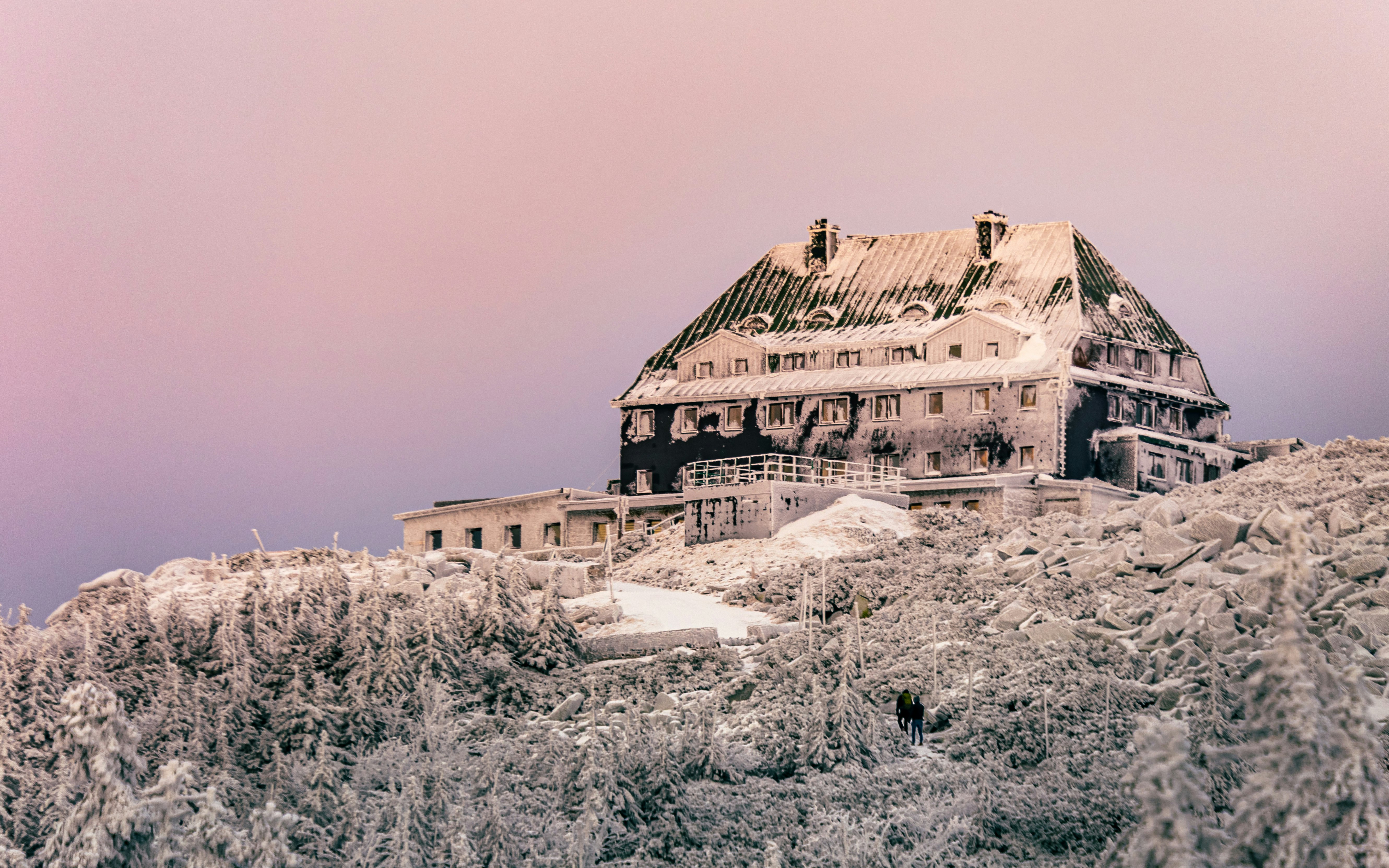 brown concrete building on snow covered ground